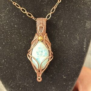 Copper wire wrapped Larimar cabochon necklace. Chain is 20 inches.